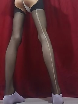 A feminine looking person’s buttocks is penetrated and is under a thin cloth that covers the genitalia.